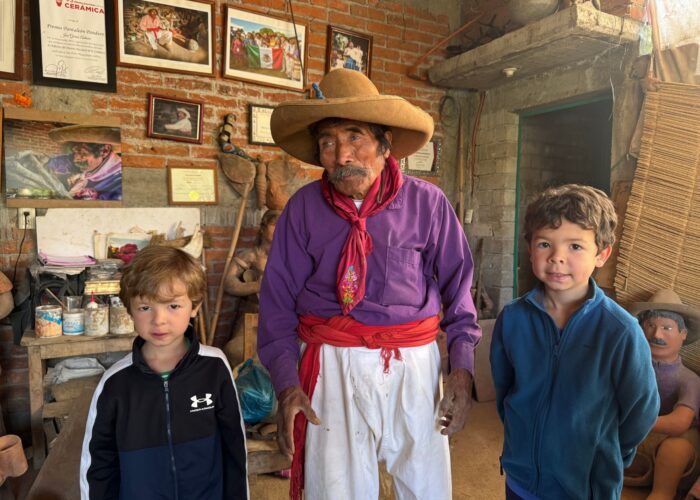 Master potter José García Antonio with young guests at Manos que Ven clay workshop on an Oaxaca artisan tour by Mexico Foodie Tours