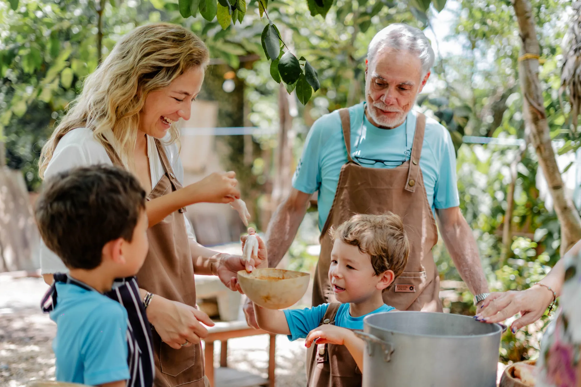 family-cooking-class-mayan-village-yucatan-by-mexico-foodie-tours Family with two children enjoying a hands-on cooking class in a Mayan village in Yucatán, a small-group experience by Mexico Foodie Tours