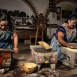 traditional-women-cooks-culinary-tourism Two traditional women cooks part of Círculos de Sabor, grinding maize and chiles on stone metates in Mexico.